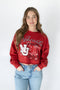 Person wearing a red 'Nebraska Huskers' sweatshirt with a white background