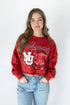 Person wearing a red 'Nebraska Huskers' sweatshirt with a white background